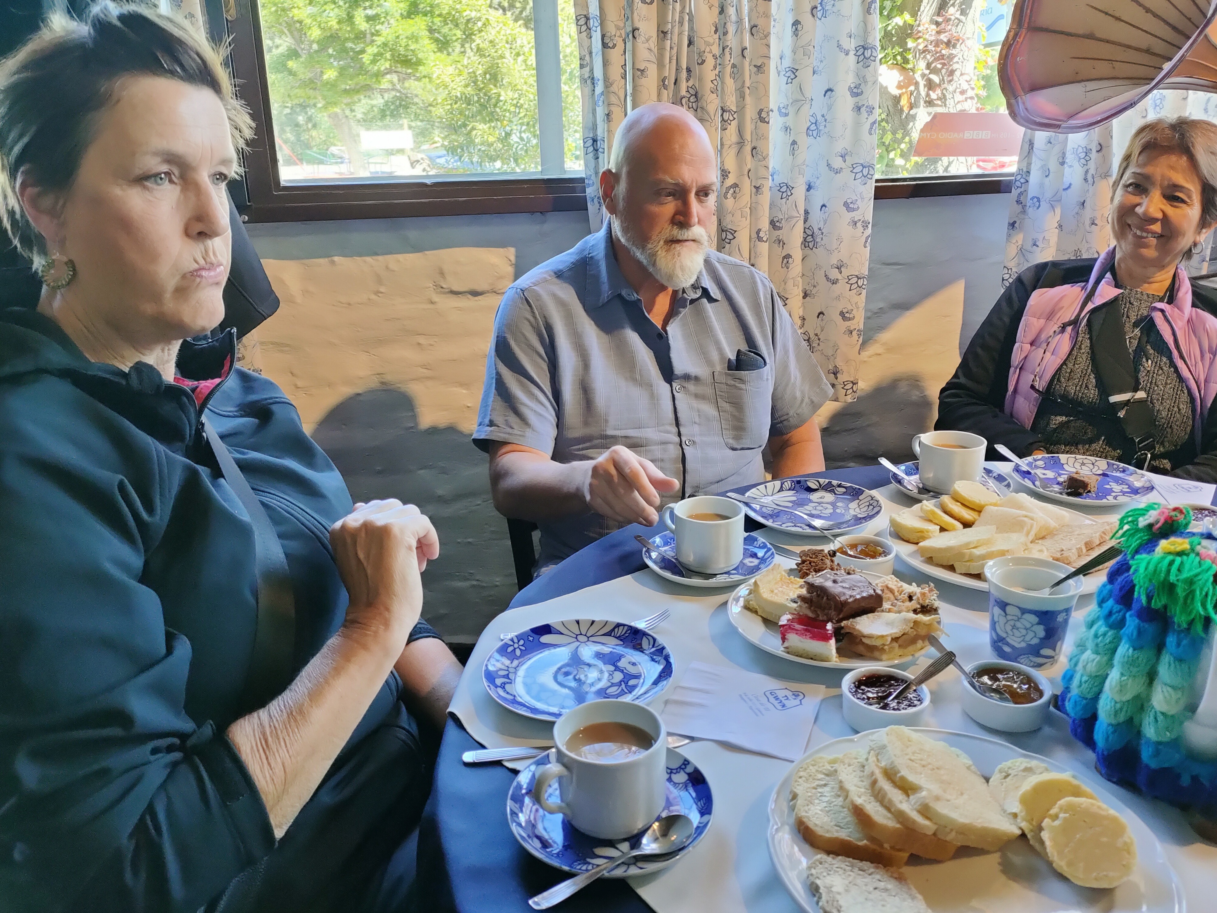 A welsh tea - basically bread and butter, scones with jams (but no cream!!!) and cakes , cakes, cakes galore. Plus a brightly coloured knitted tea cosy centre stage, and a lady who seems to be laughing at me.